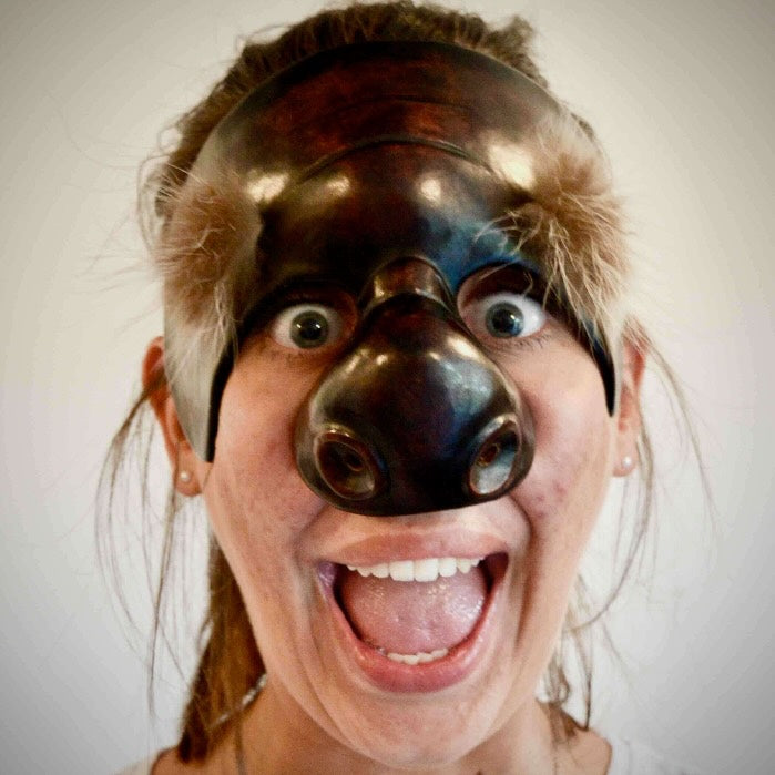 a person wearing a Dottore Commedia mask.